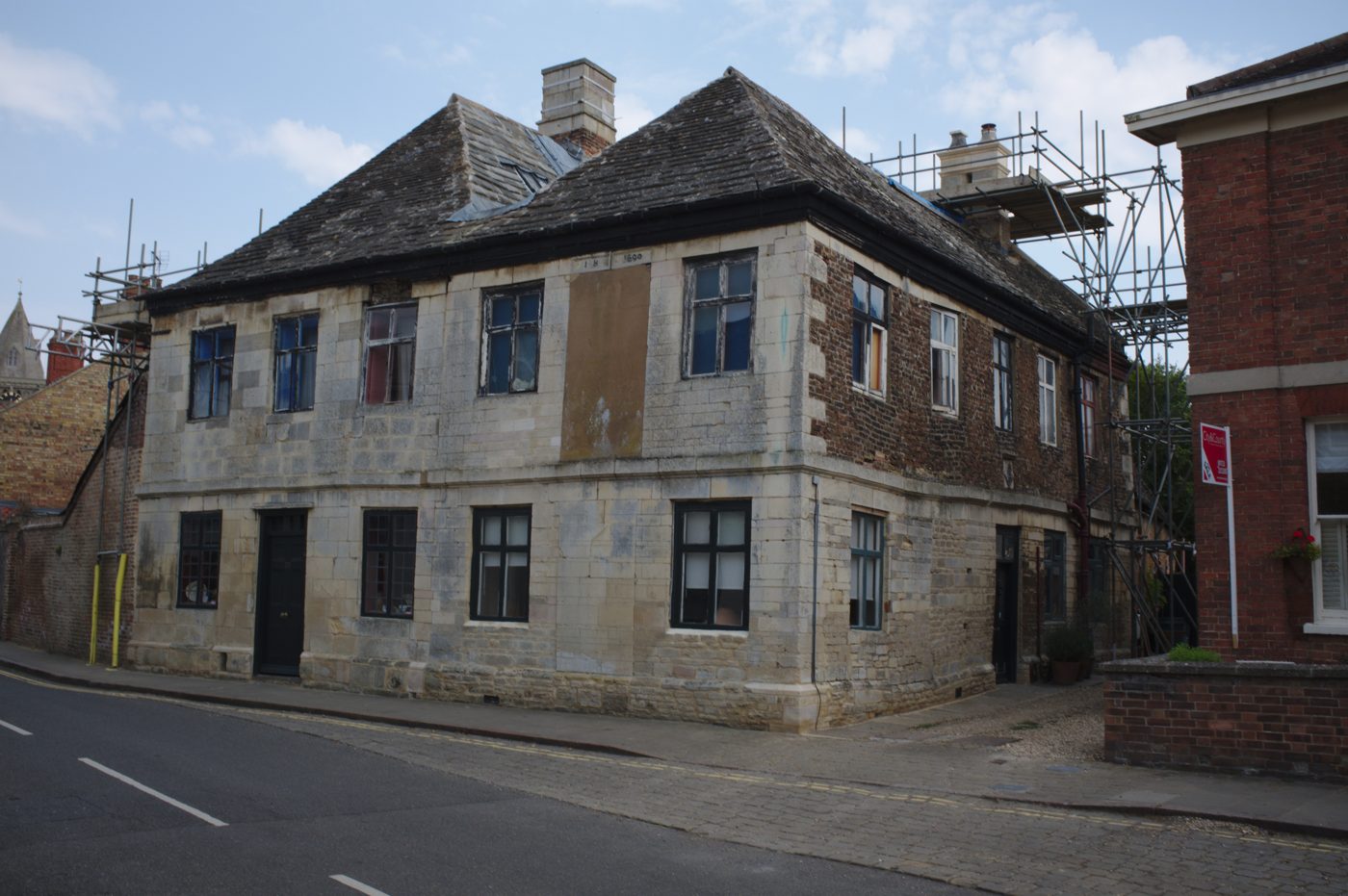 Chimney and roof repair work with scaffolding on a UK building