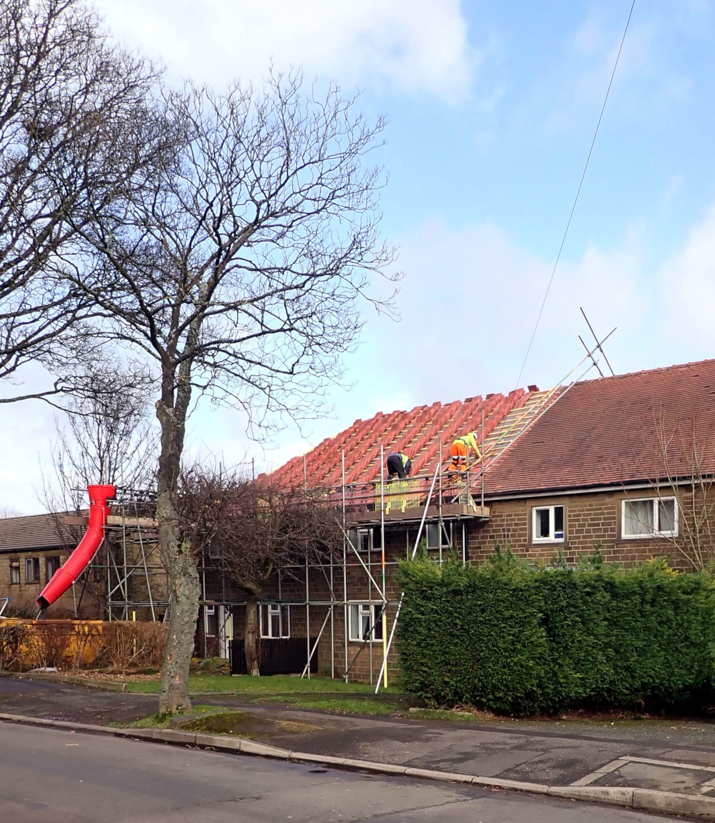 Roof repair in progress with scaffold on a UK house