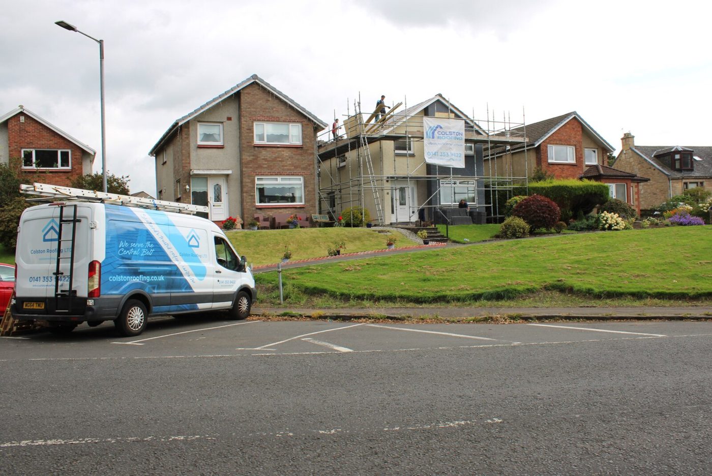 Re-roofing in progress on scaffolded terraced houses