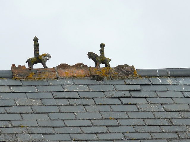 Ridge tiles and finials along the top of a slate roof